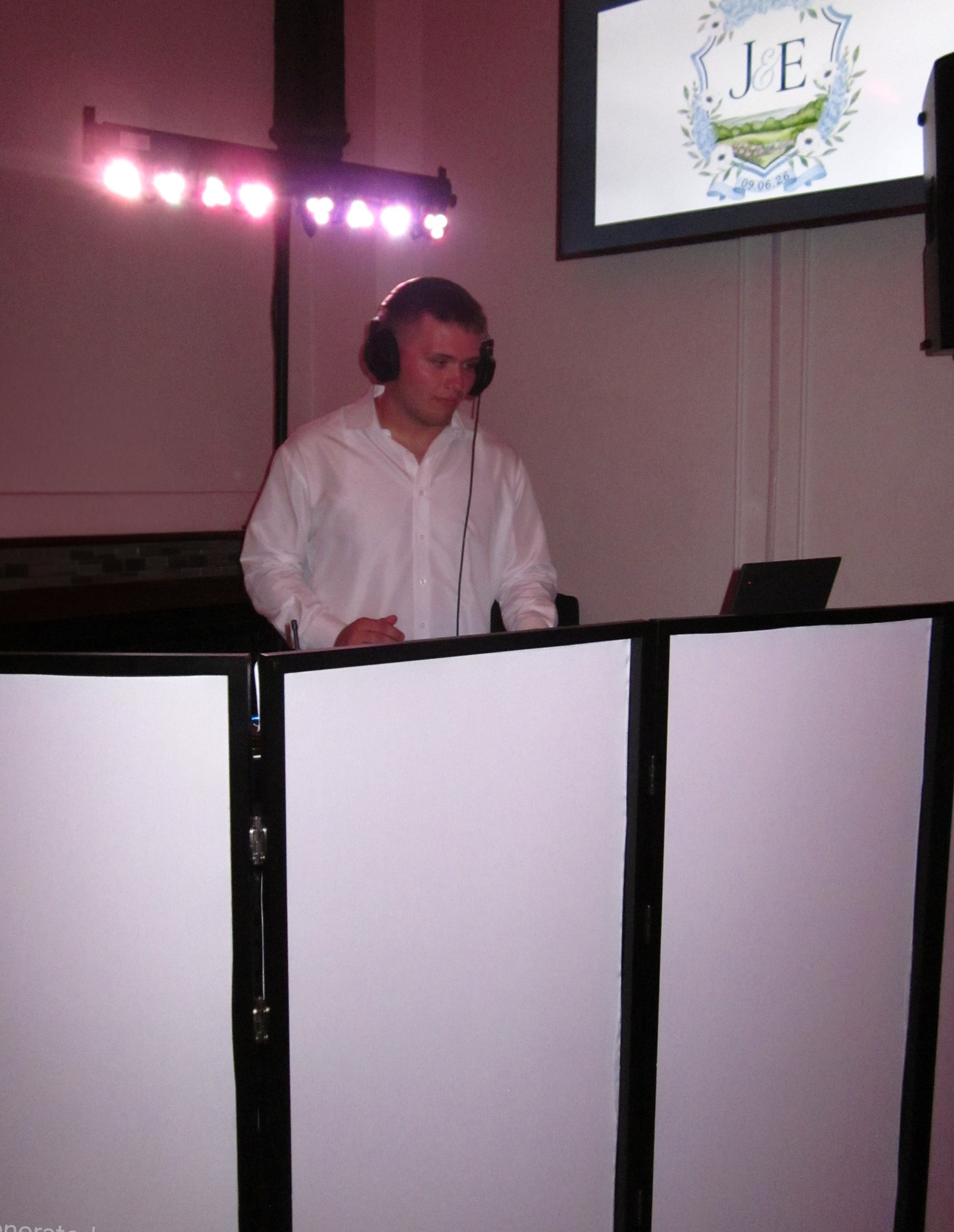 DJ Crim behind the booth at a wedding reception